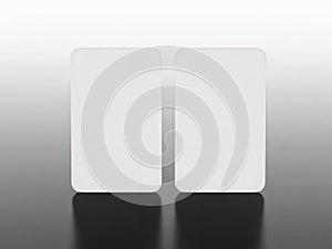 Two white rectangular objects on reflective surface isolated on white background