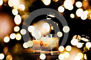 Two white russian cocktails with festive bokeh lights