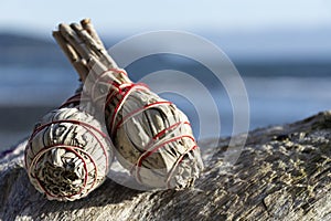 Two White Sage Smudge Sticks and Ocean Close Up