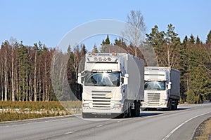 Two White Semi Trucks Platooning