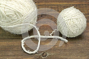 Two White Sheep Wool Roll On Wooden Bckground