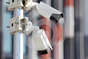 Two white surveillance security cctv cameras