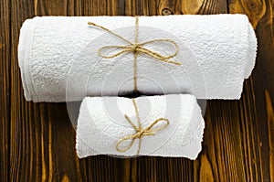 Two white towels on wooden background