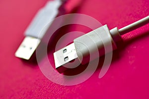 Two white USB connectors on a red background