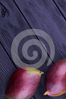 Two whole mangoes, vertical image.