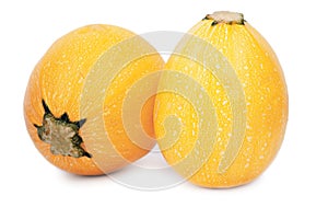 Two whole yellow zucchinies. Colorful and healthful ripe zucchinies on a white background. A tropical orange zucchini.