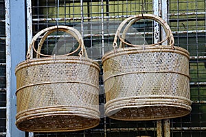 Two Wicker baskets hanging on the curved steel.