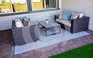 Two Wicker Couches On Rear Patio