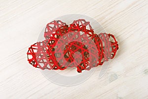 Two wicker red hearts on the wooden background