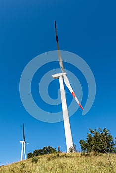 Two wind turbines above the hill - Renewable energy