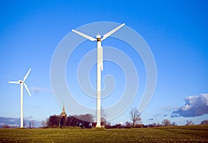 Two wind-turbines and church.