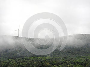 Two massive wind turbines on foggy Vermont hilltop photo
