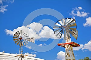 Two windmill on an agricultural farm in USA.