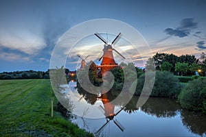 Two windmills in Greetsiel at the blue hour