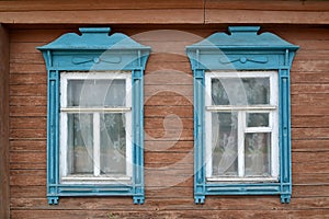 Two windows with blue carved platbands