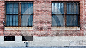 Two Windows on brick red wall