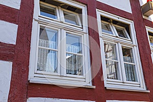 Two windows on the facade of ancient half-timbered house