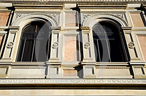 Two windows of an important and beautiful building behind the Basilica of San Petronio