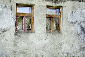 Two windows old clay wall