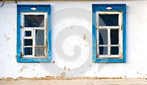 Two windows old clay wall