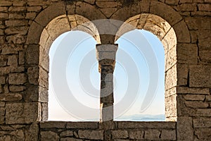 Two windows in an old tower or fortress, view from the inside
