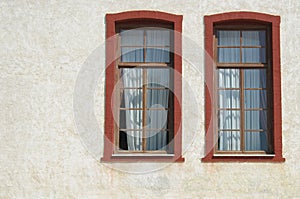 Two windows on white wall