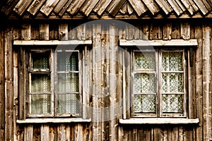 Two windows in a wooden cottage