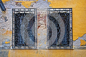 Two windows in a yellow old wall, Venice