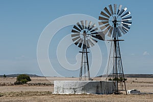 Two windpumps and a farm dam in Karoo Region South Africa photo