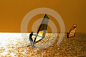 Two windsurfers