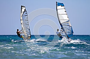 Two windsurfers in action