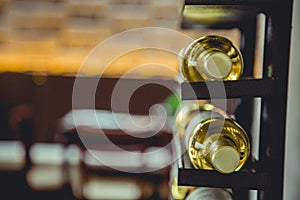 Two wine botles in a stand