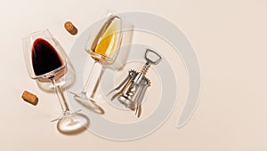 Two wine glasses alongside a corkscrew and several corks