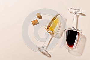 Two wine glasses alongside several corks