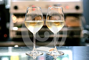 Two wine glasses in bar. Date time for loving people inside restaurant or cafe