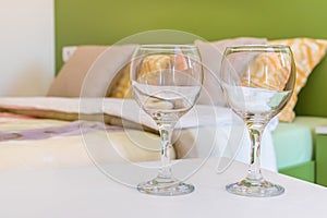 Two wine glasses in bedroom