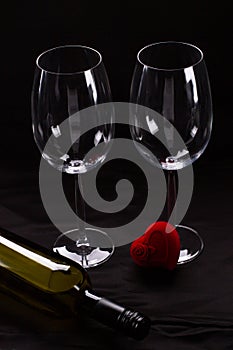 Two wine glasses, bottle and gift box.