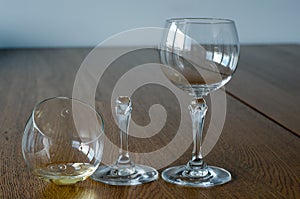 Two wine glasses. One half full broken glass and empty undamaged photo