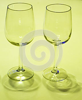 Two wine glasses on white-green background