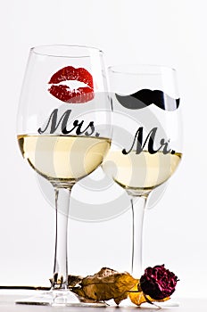 Two wine glasses with wine isolated on a white background. Glasses for woman and man. White wine. Happy lifestyle. Romantic.