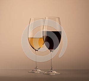 Two wineglass one half full of white wine one red