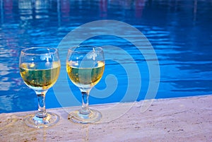 Two wineglasses at the poolside