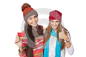 Two winter girls showing blank card