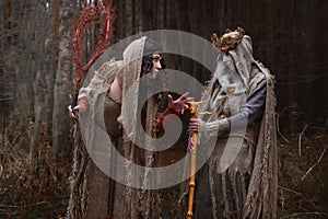 Two witches in rags in forest