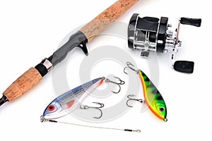 Two wobblers, casting spinning and baitcasting reel in black on a white background, isolate