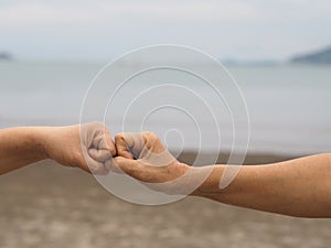 Two woman Alternative handshakes fist clenched hand greeting in the situation of an epidemic covid 19, coronavirus new normal