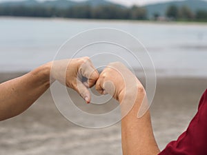 Two woman Alternative handshakes fist clenched hand greeting in the situation of an epidemic covid 19, coronavirus new normal