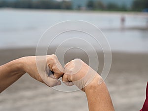 Two woman Alternative handshakes fist clenched hand greeting in the situation of an epidemic covid 19, coronavirus new normal