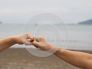 Two woman Alternative handshakes fist clenched hand greeting in the situation of an epidemic covid 19, coronavirus new normal