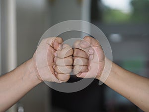 Two woman Alternative handshakes Fist collision Bump greeting in the situation of an epidemic covid 19, coronavirus